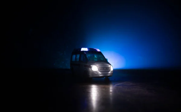 Corona virus concept with Ambulance car. Stay home for precautionary measures to prevent from corona virus. Ambulance car on dark misty background. Creative artwork decoration. Selective focus