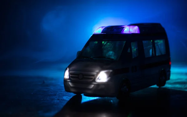Corona virus concept with Ambulance car. Stay home for precautionary measures to prevent from corona virus. Ambulance car on dark misty background. Creative artwork decoration. Selective focus