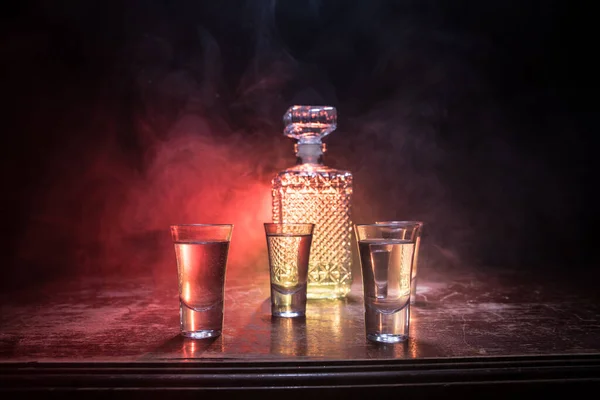 Beautiful Carafe Vodka Stands Wooden Table Glasses Dramatic Toned Foggy — ストック写真