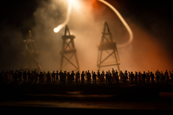 Oil industry crisis concept. Oil stock crisis because Covid global pandemic. Oil pump and oil refining factory at night with fog and backlight. Creative artwork decoration. Selective focus.