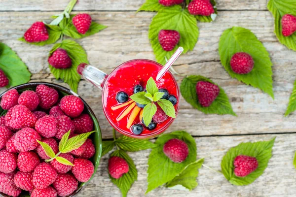 Raspberry smoothie in a glass jar, drink with fresh berries, juicy fruit mousse, natural detox cocktail from above — Stock Photo, Image