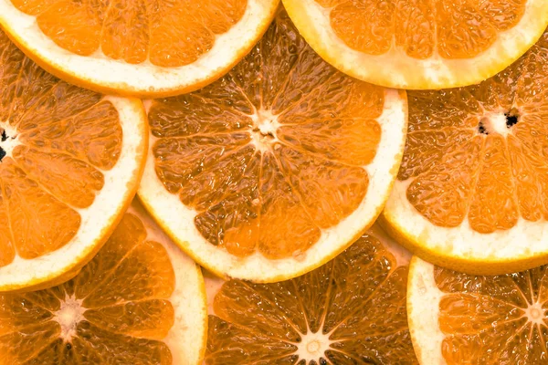Textuur van stukjes sinaasappel, close-up, overhead, citrus achtergrond — Stockfoto