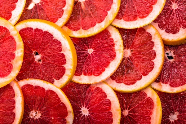 Текстура ломтиков грейпфрута, накладные расходы, крупный план, цитрусовые фоны — стоковое фото