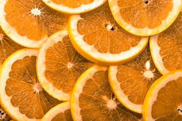 Текстура нарезанных апельсинов, естественный фон — стоковое фото