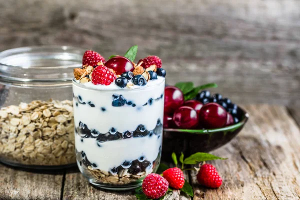 Healthy yogurt with berry fruits in a glass cup, summer dessert and weight loss concept
