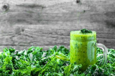 Yeşil lahana taze yüzlü kavanoz, detoks içecek ahşap masa üzerinde bırakır