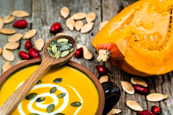 Pumpkin soup with seeds, vegan food, cooking concept