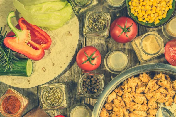 Zubereitung von Tortilla mit Gyros, Streifen Hühnerfleisch und pflanzlichen Zutaten, hausgemachtes Kochrezept, flache Lage von oben — Stockfoto