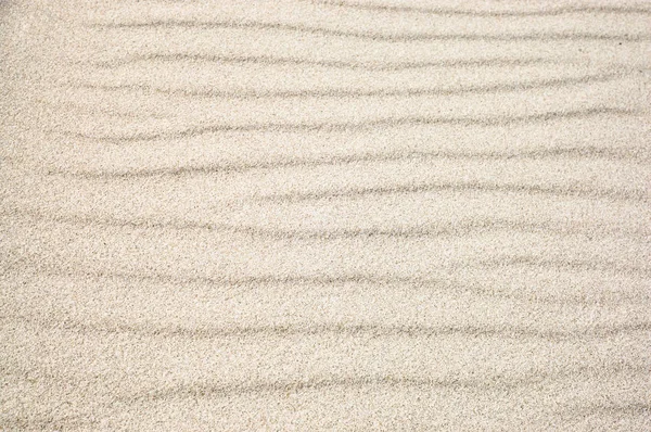 Background of sand, texture, sandy waves on the beach, pattern in nature — Stock Photo, Image