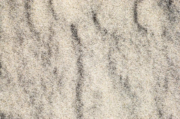 Background of sand, texture, sandy waves on the beach, pattern in nature — Stock Photo, Image