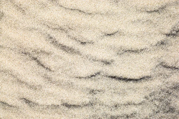 Fundo de areia, textura, ondas de areia na praia, padrão na natureza — Fotografia de Stock