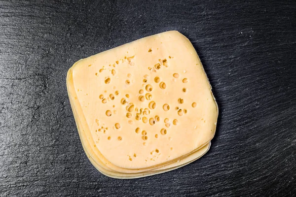 Yellow cheese slices, top view