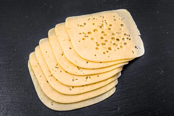 Yellow cheese slices, top view