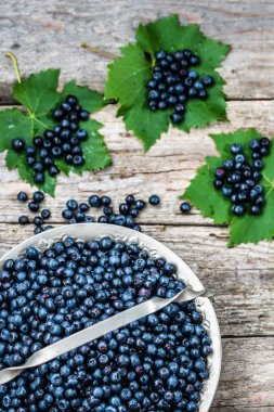 Ahşap masa, ormandaki çiftçi piyasasında olgunlaşmış meyve sepeti taze yaban mersini alanı, üstten görünüm Kopyala