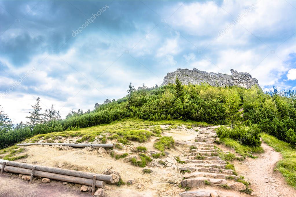 Rocky mountain above hiking trail, view on rocks on top of mountains, landscape