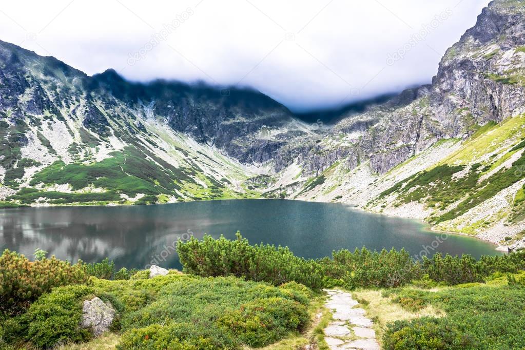 Mountain lake landscape with hiking trail, National Park in Tatra Mountains