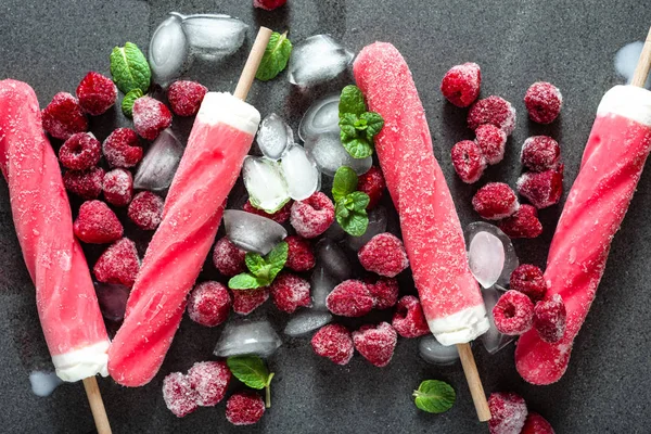 Flavored ice pop from fruit sorbet with frozen raspberries