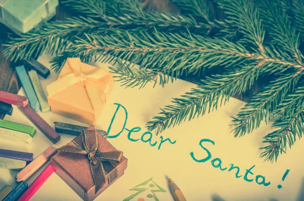 Christmas letter to Santa Claus. White paper to writing and gift boxes.