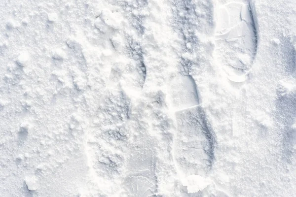 Huellas en la nieve, textura de invierno para el fondo de diseño — Foto de Stock