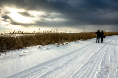 Göl, kış ve günbatımı moody gökyüzü, romantik Sevgililer günü kavramı manzara üzerinde yürüme Çift
