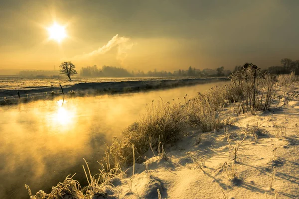 Winter river, landscape, morning sun glare in the water