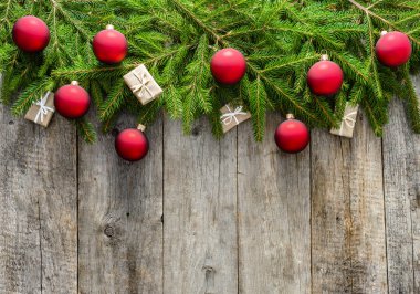 Süslemeleri Noel hediye kutuları ve süs eşyaları - köknar dallarda boş kopya alanı ile ahşap arka plan asılı kırmızı cam topları ile