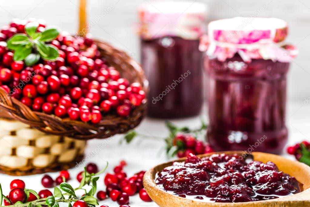 Red berry jam in a jar on table, natural organic product - homemade preserve for winter