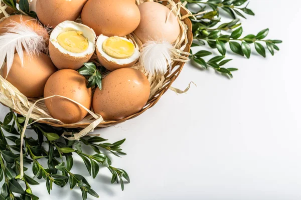 Easter eggs in easter basket on white background.