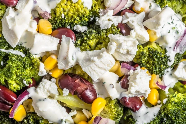 Broccoli salad with vegetables and feta cheese.