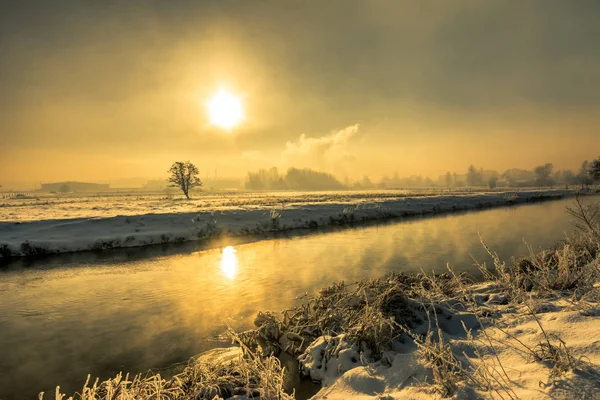 Winter river, landscape, morning sun glare in the water