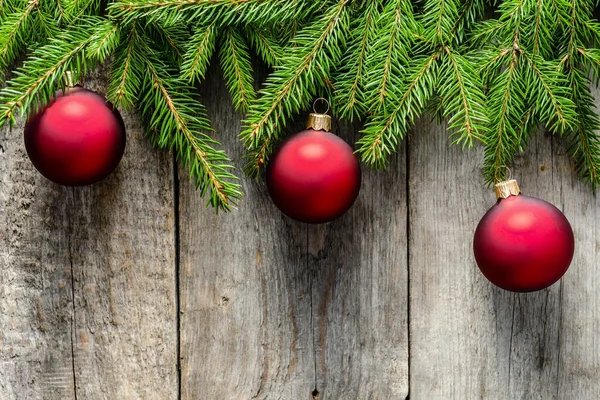 Fondo in legno con ornamenti natalizi su rami di abete verde, vista dall'alto — Foto Stock