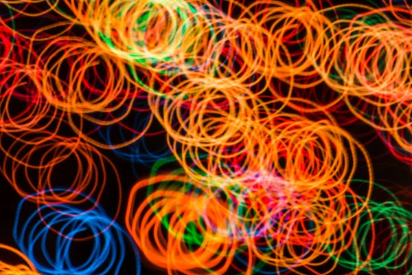 Abstract background with lights in blurred motion in the night or fireworks in new years eve — Stock Photo, Image