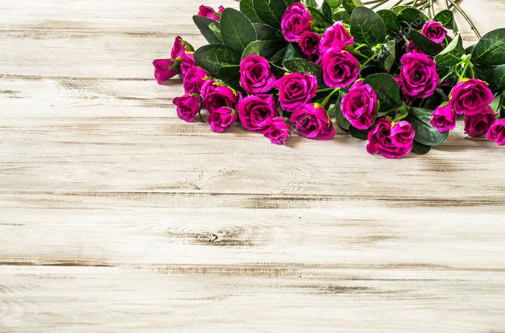 Bouquet of roses for women's day background or mother's day gift, flowers on wooden table, overhead