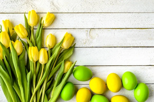 Joyeux Pâques oeufs et tulipes sur table en bois, décoration festive — Photo