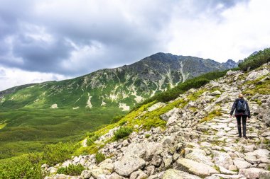 Uzun yürüyüşe çıkan kimse kadın sırt çantası, yüksek dağlar, panoramik manzara içinde taş olan yolu ile hiking dağ izinde