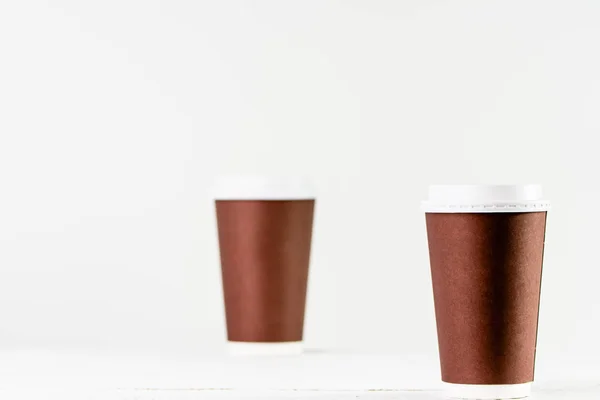 Paper cup to coffee takeaway. Brown cups with lid for safety drinking.
