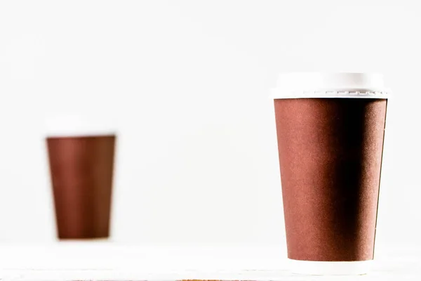 Coffee cup isolated. Brown cups with lid on white background.