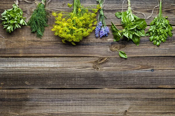 Különböző fűszernövények a kertből, fa asztalon. Friss fűszernövény, felülnézet, lapos tojásrakás — Stock Fotó