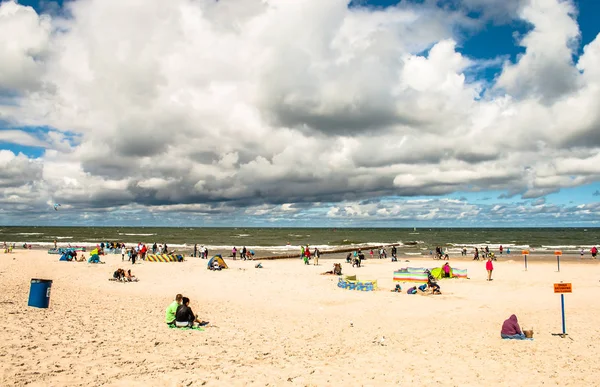 LEBA, POLÔNIA - 17 de julho de 2015: As pessoas desfrutando na praia na cidade de Leba, mau tempo, céu nublado, mar Báltico, Polônia — Fotografia de Stock