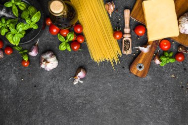 Italian food ingredients of spaghetti: tomatoes, basil, garlic, olive oil and parmesan cheese