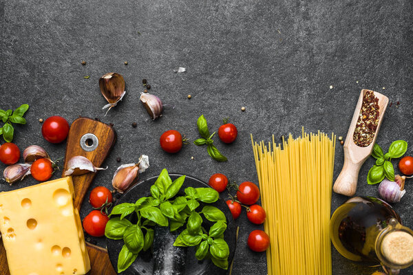 Italian food ingredients of spaghetti bolognese: tomatoes, pasta, basil, cheese and spices