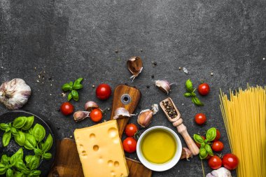 Italian food, cooking ingredients of spaghetti: pasta, tomatoes, basil, garlic, olive oil and cheese