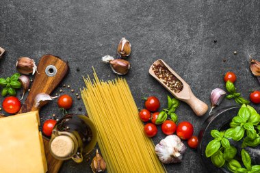 Italian food ingredients of spaghetti: tomatoes, basil, garlic, olive oil and parmesan cheese