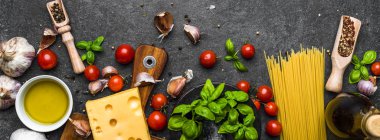 Italian food ingredients of spaghetti bolognese: tomatoes, pasta, basil, cheese and spices