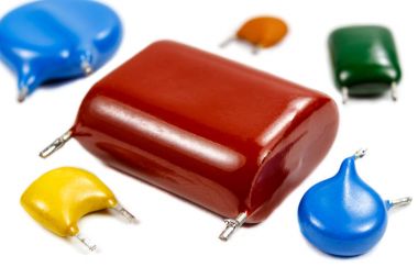 Set of the used capacitors of various types on a white background clipart