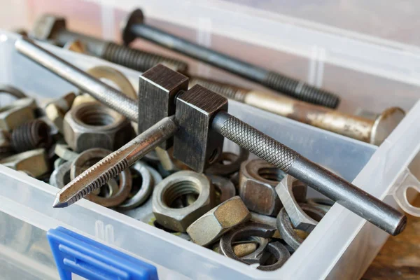 Machine tap with the old bolts and nuts in a storage box — Stock Photo, Image