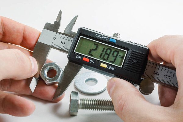 Measurements by a digital caliper in the master's hand