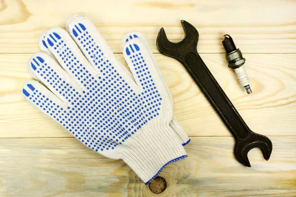 Open-end wrenches with the spark plug and protective gloves