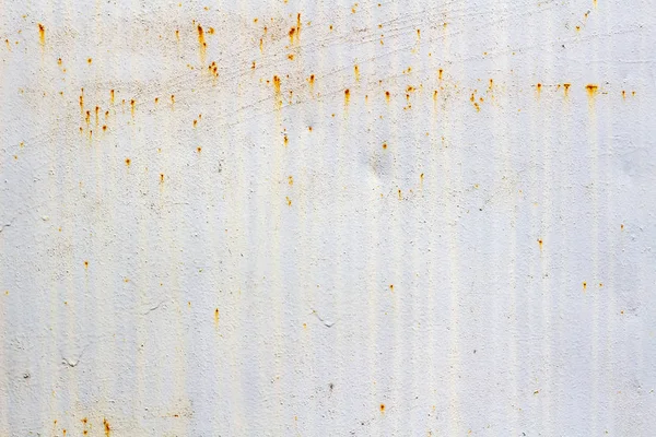 White painted surface of metal sheet with traces of corrosion. Abstract background