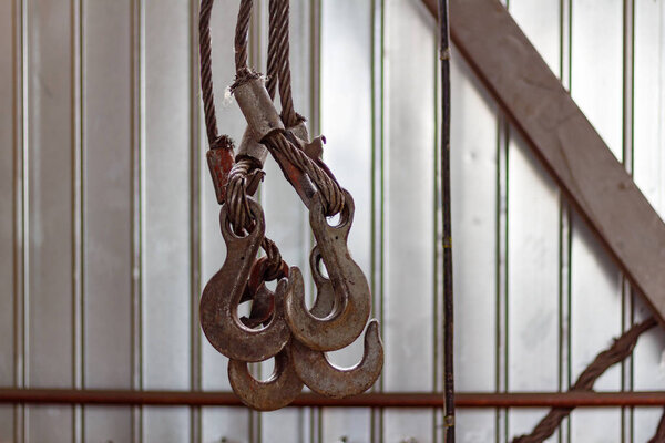 Overhead crane hooks closeup in the assembly workshop